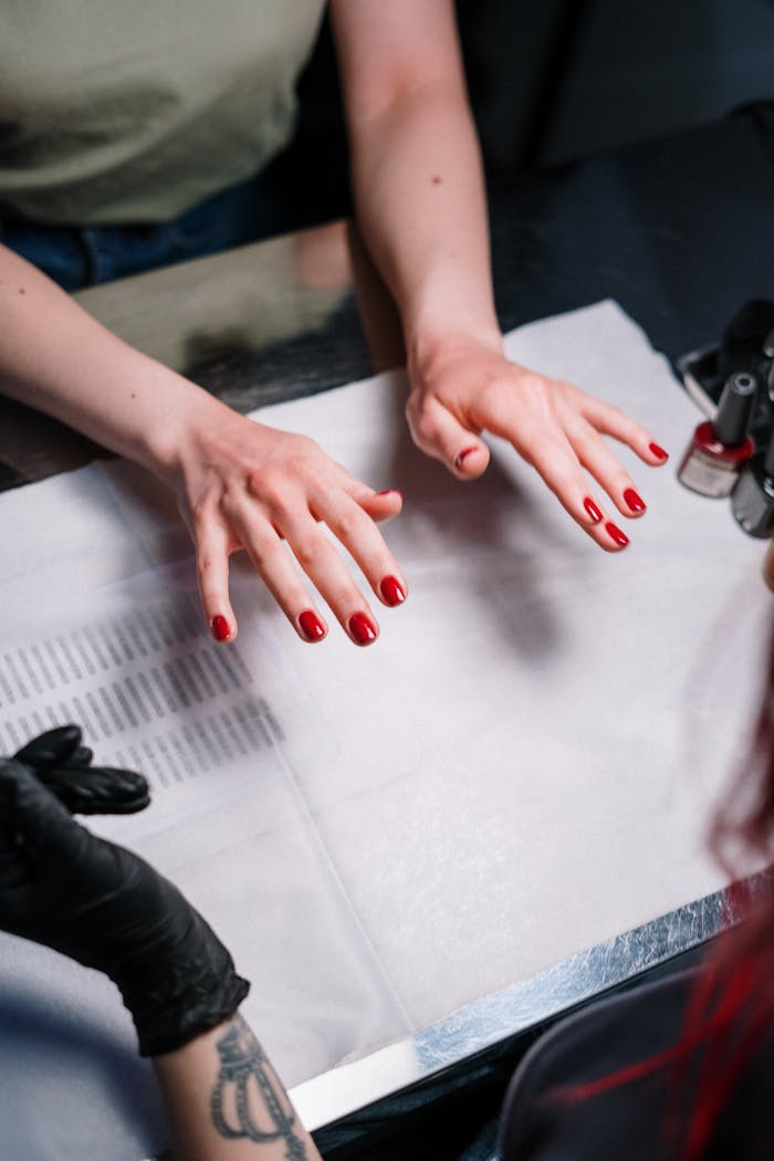 Close-up of a professional manicure with red nail polish in a beauty salon.